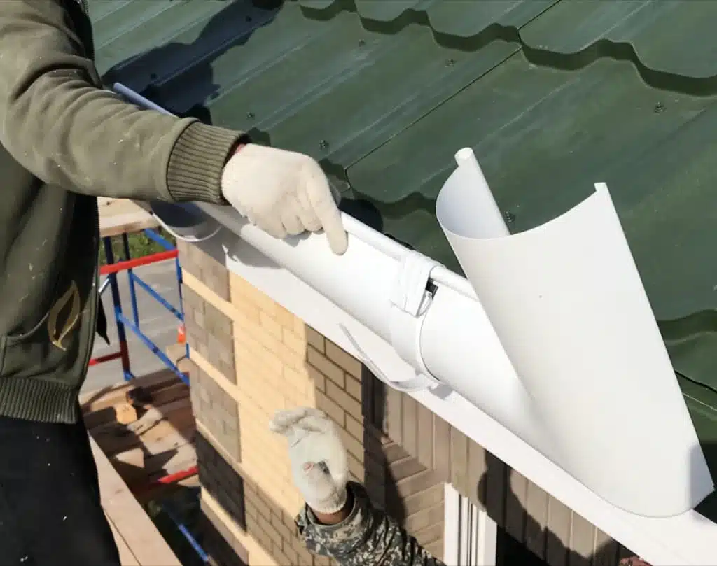 Installing Seamless Gutters on a home exterior in Wichita, Kansas