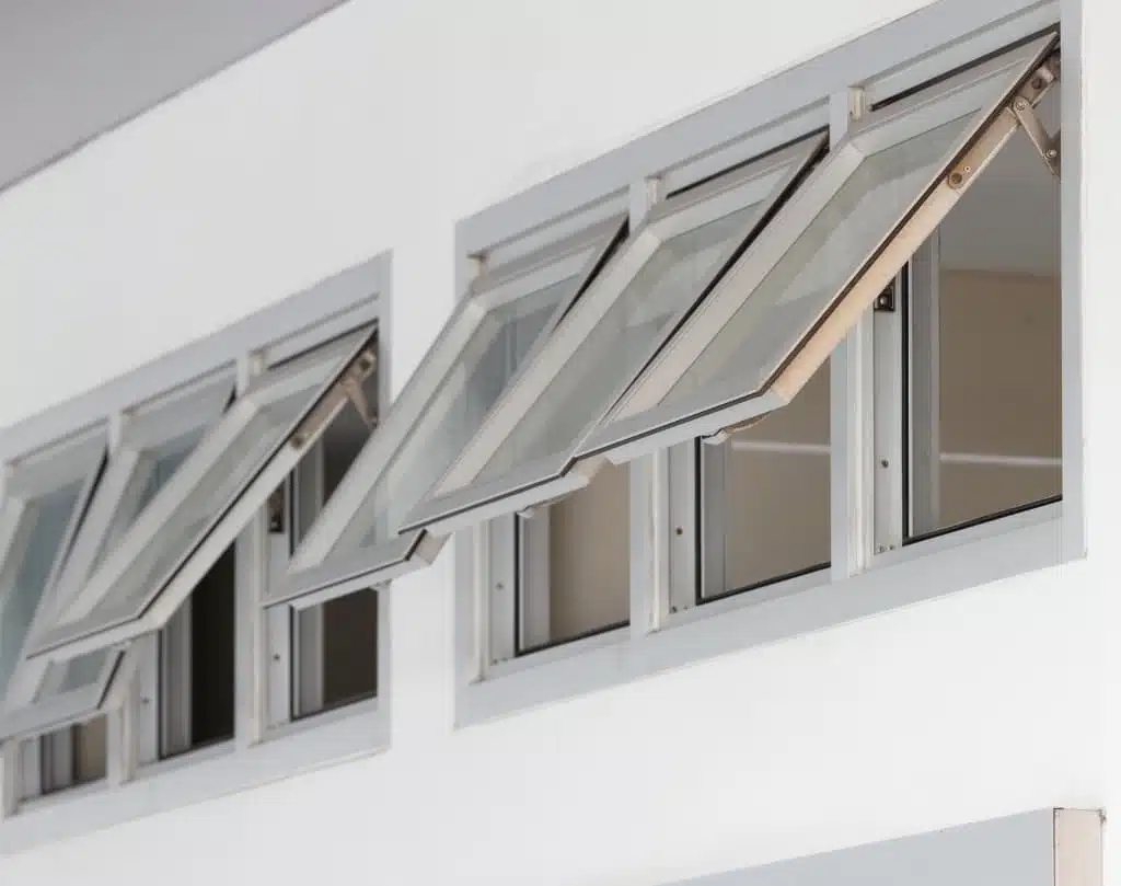 A pair of windows with their awnings open.