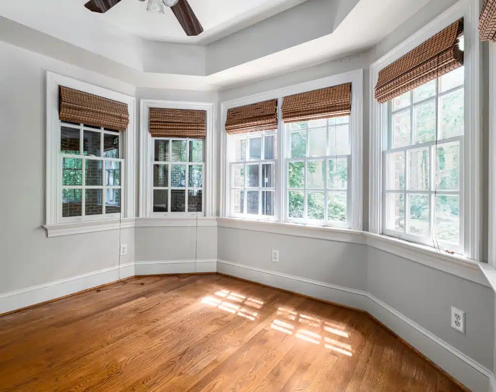 A room with many windows and wooden floors