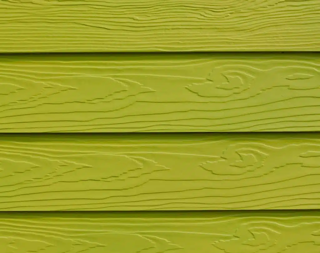 A close up of the wood grain on a green wall.