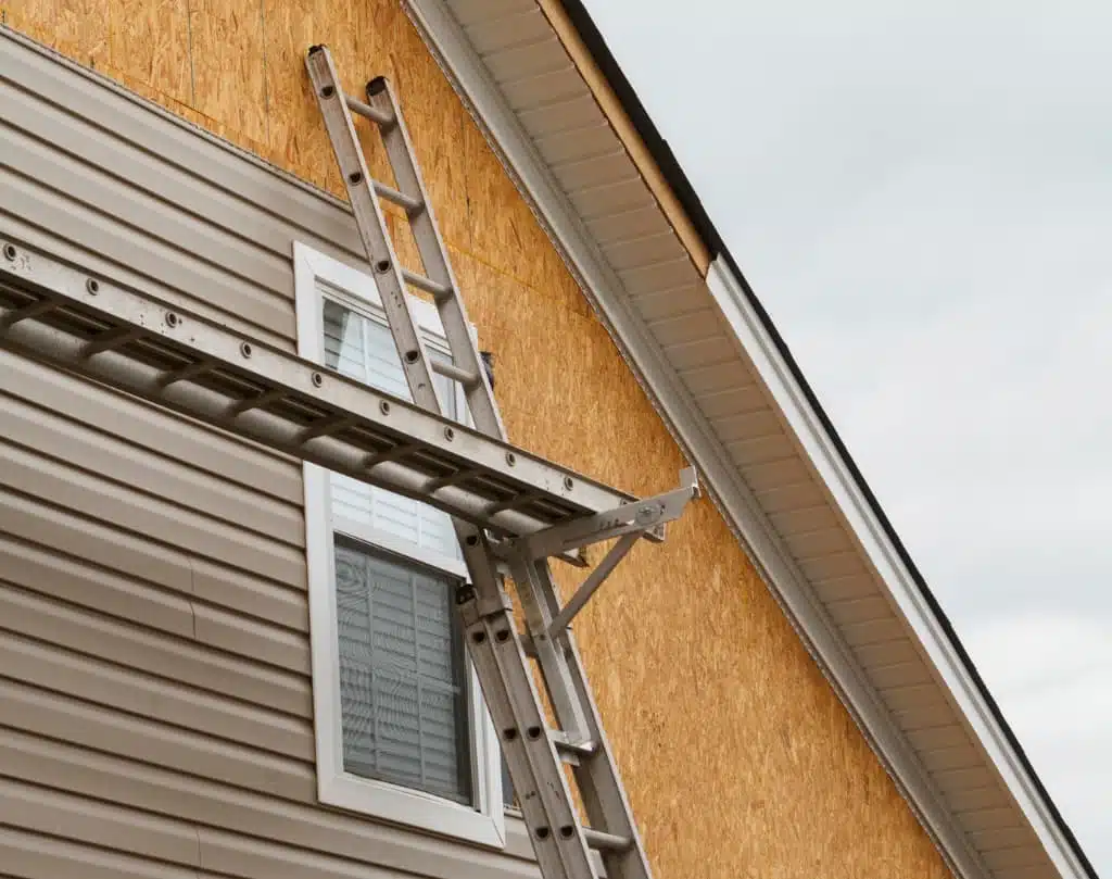 A ladder is attached to the side of a house.