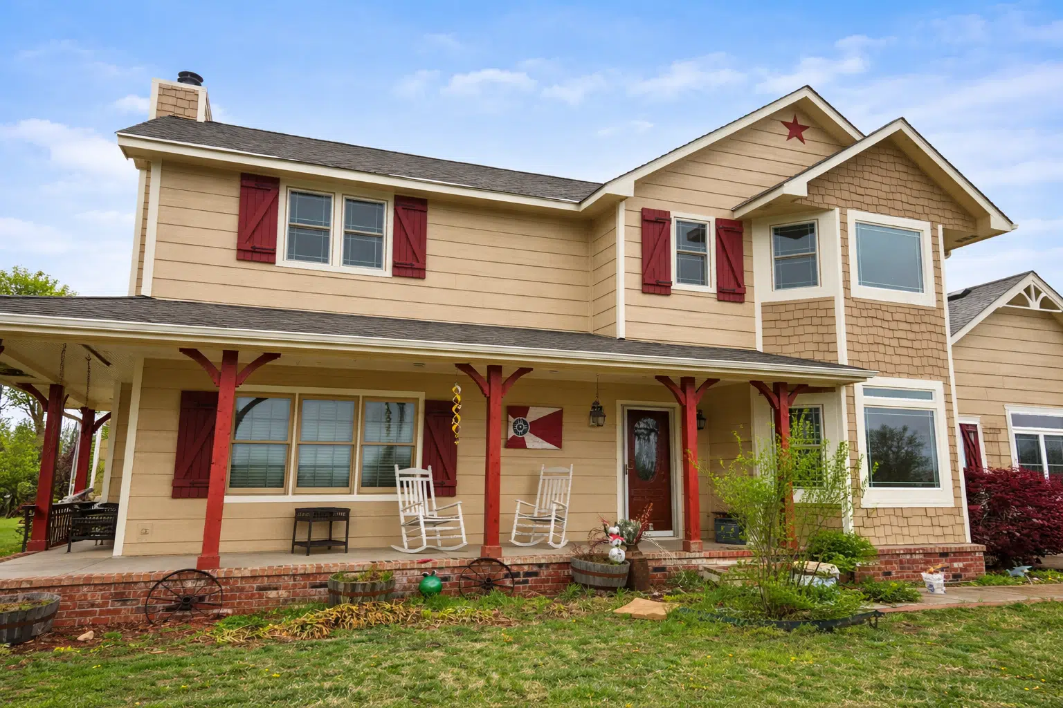 Farmhouse siding installation with red shutters on home exterior in Wichita, KS by Greenway Exteriors